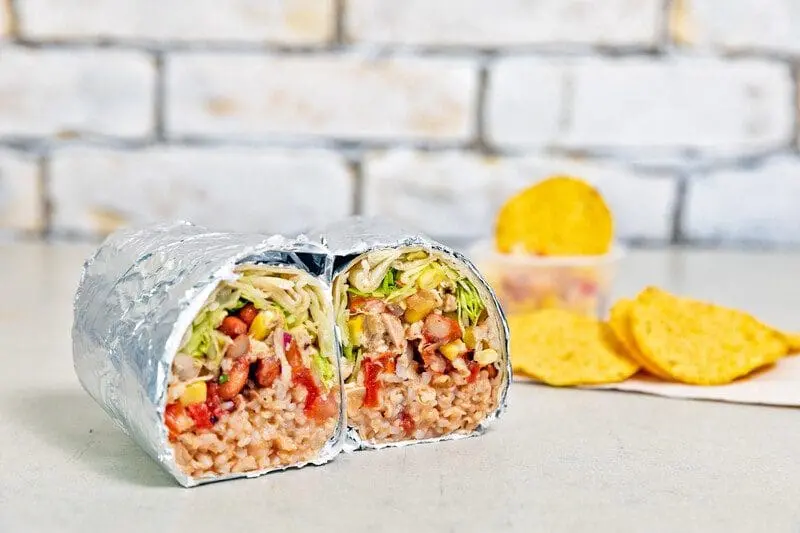 Burrito and chips on table