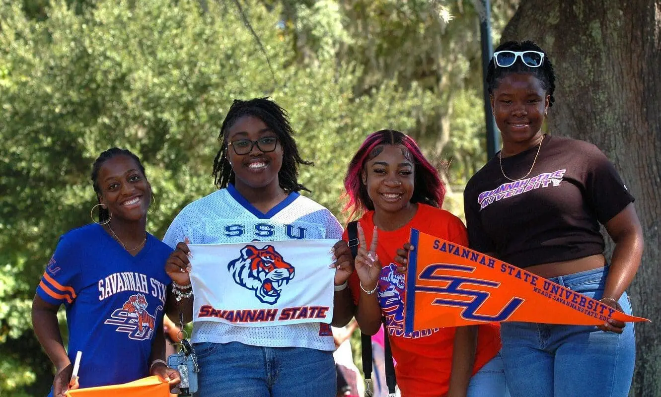 Students holding school banners