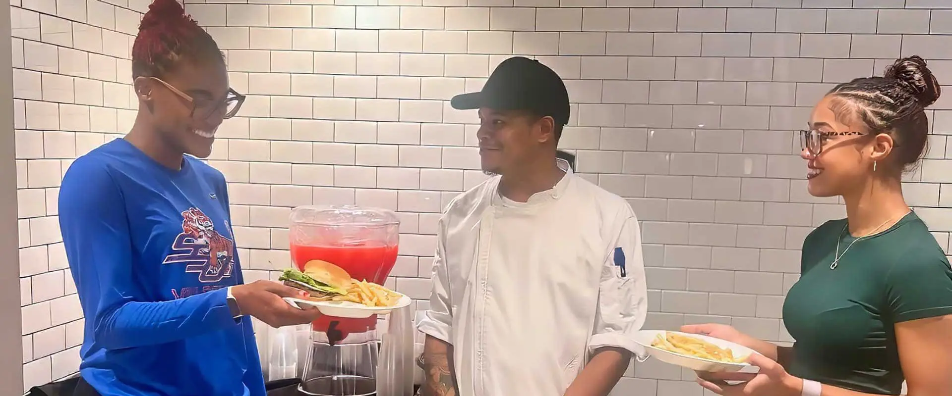 Two students talking to chef
