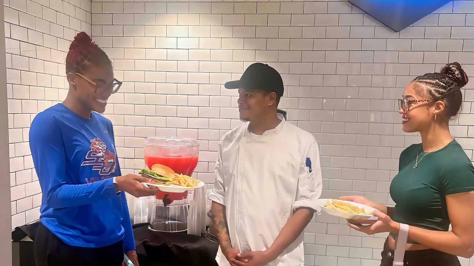 Two students talking to chef