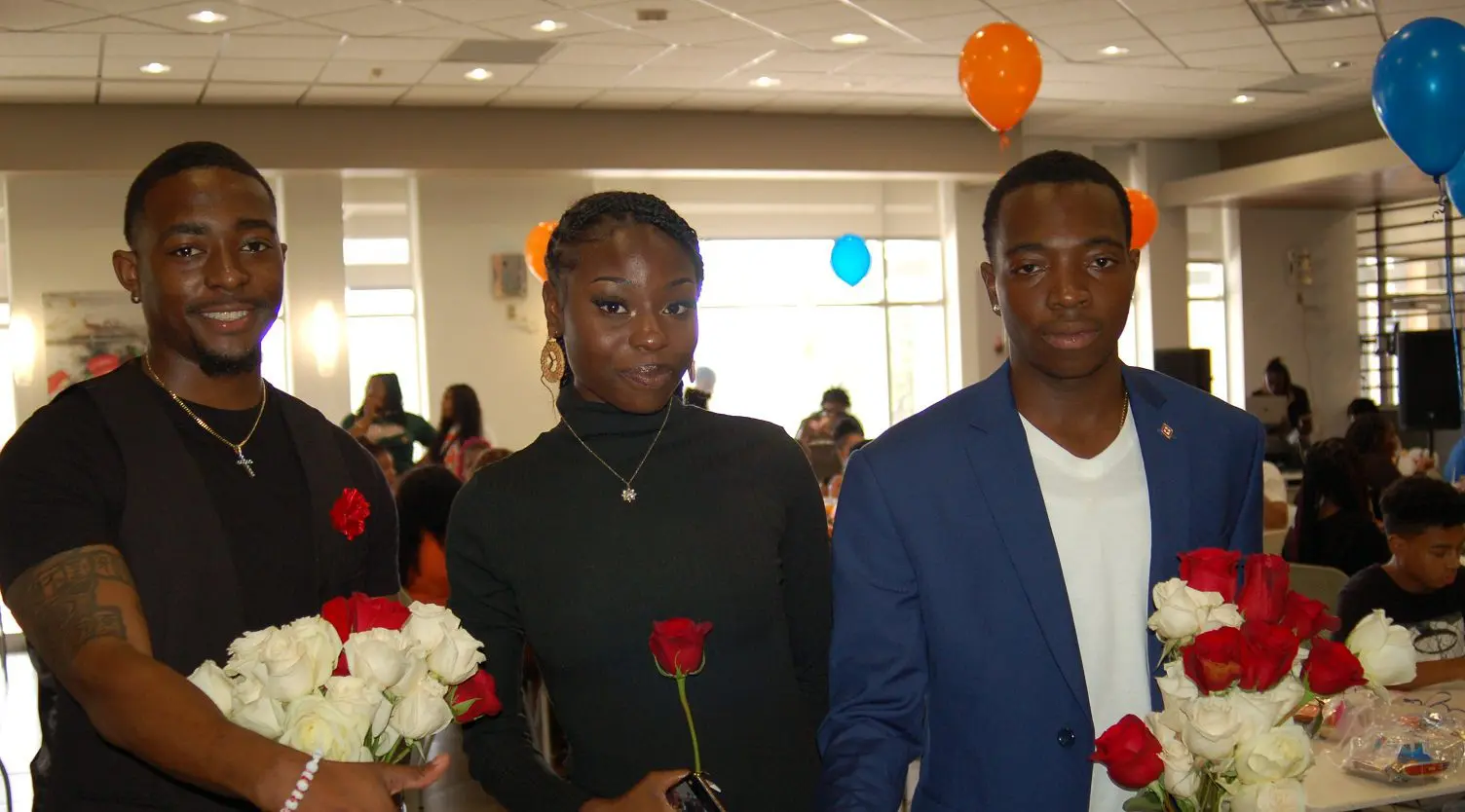 Students in cafeteria holding roses