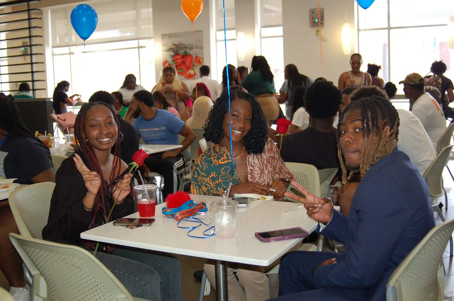 Students sitting at table in cafeteria